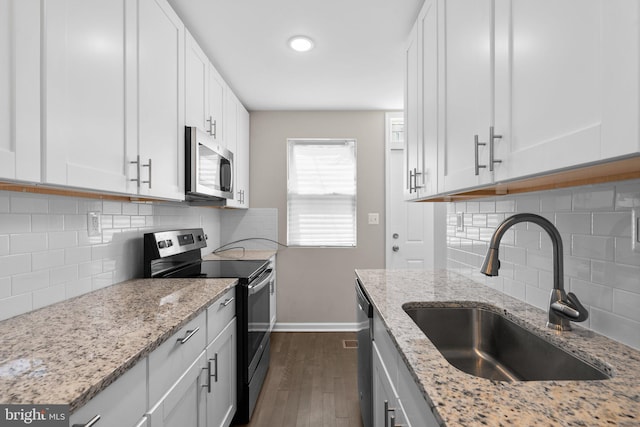 1414 N Bethel St, Baltimore, MD 21213 - kitchen with stainless steel appliances, a sink, baseboards, decorative backsplash, and dark wood-type flooring