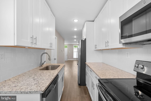 1414 N Bethel St, Baltimore, MD 21213 - kitchen featuring stainless steel appliances, a sink, wood finished floors, white cabinetry, and recessed lighting