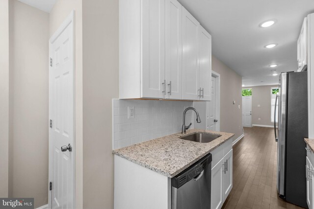 1414 N Bethel St, Baltimore, MD 21213 - kitchen featuring stainless steel appliances, a sink, backsplash, recessed lighting, and white cabinetry