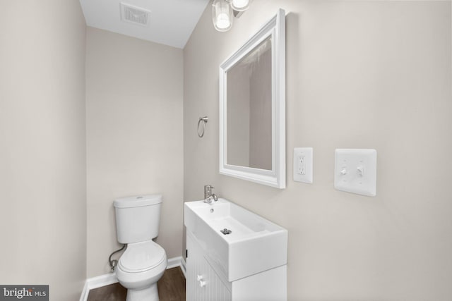 1414 N Bethel St, Baltimore, MD 21213 - bathroom featuring toilet, vanity, baseboards, and wood finished floors