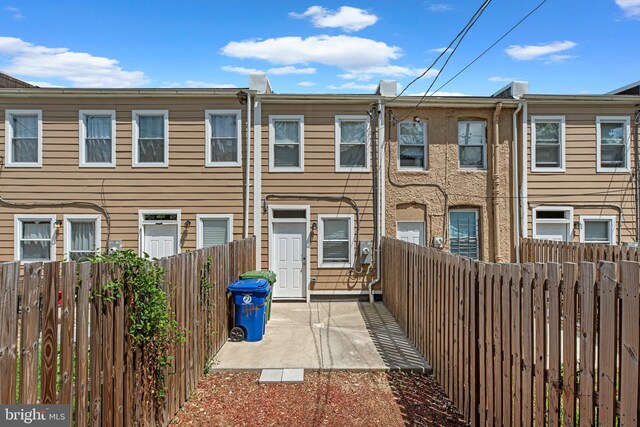 1414 N Bethel St, Baltimore, MD 21213 - view of front of house with a fenced backyard and a patio area