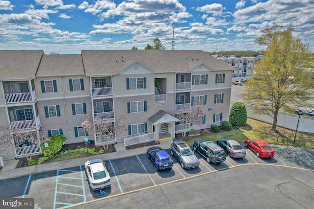 view of building exterior with uncovered parking