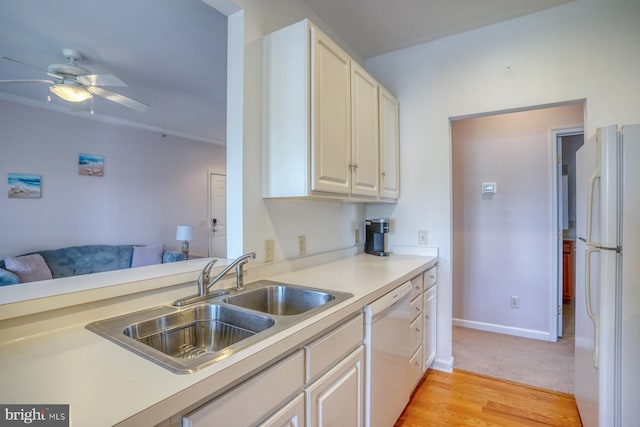 kitchen with a sink, white appliances, light countertops, a ceiling fan, and baseboards
