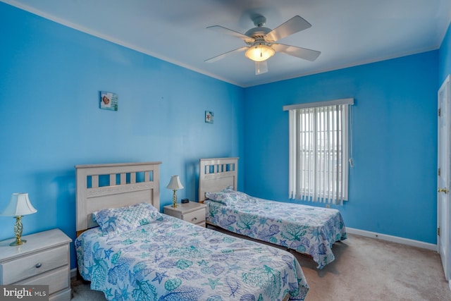 carpeted bedroom featuring baseboards and ceiling fan