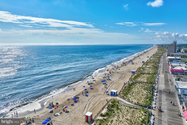 aerial view with a water view and a beach view