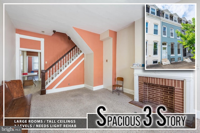 interior space with baseboards and a brick fireplace