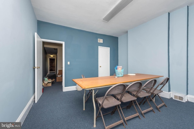 carpeted dining space with baseboards and visible vents