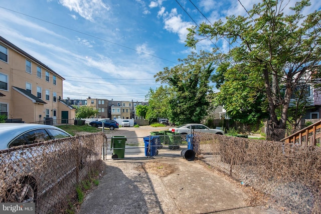 view of road with a residential view and a gate