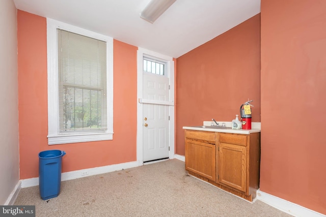 entrance foyer featuring baseboards and carpet floors