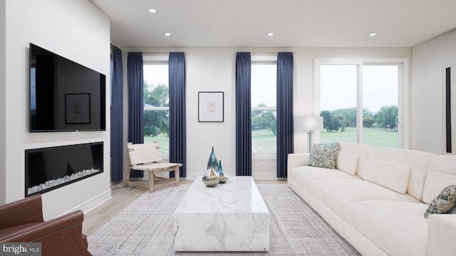 living room with recessed lighting, baseboards, and light wood-style floors