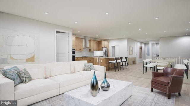 living area with recessed lighting and light wood-type flooring