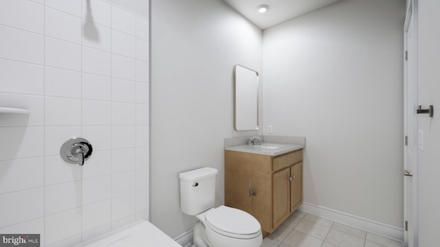 full bathroom with vanity, tile patterned flooring, a tile shower, and toilet