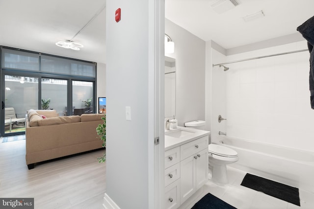 full bathroom with visible vents, vanity, wood finished floors, toilet, and bathtub / shower combination
