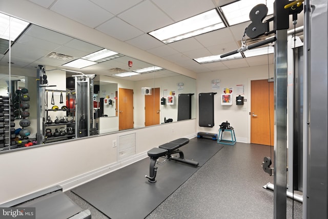 gym featuring visible vents, baseboards, and a drop ceiling