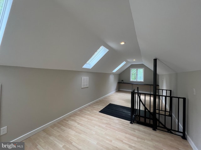 8122 Stacey Rd, Alexandria, VA 22308 - additional living space with a skylight, wood finished floors, vaulted ceiling, and baseboards