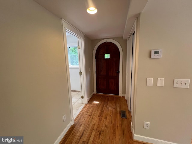 8122 Stacey Rd, Alexandria, VA 22308 - hall with light wood-style floors, visible vents, baseboards, and arched walkways