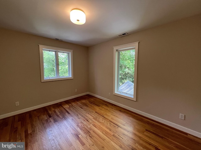 8122 Stacey Rd, Alexandria, VA 22308 - unfurnished room with healthy amount of natural light, baseboards, and wood finished floors