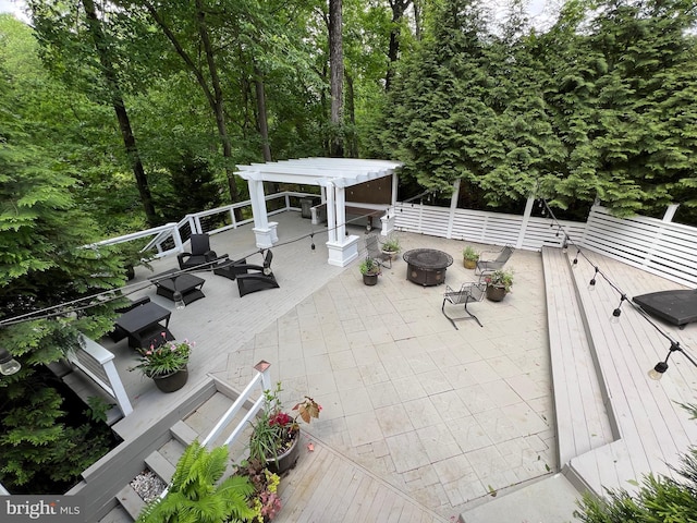 8122 Stacey Rd, Alexandria, VA 22308 - view of patio featuring a wooden deck, a fire pit, and fence