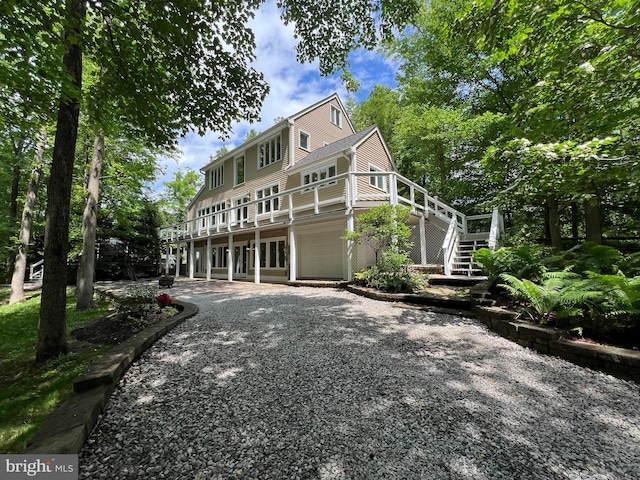 8122 Stacey Rd, Alexandria, VA 22308 - back of property with driveway, a deck, a garage, and stairs