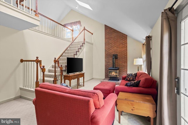 3161 Grande Oak Pl, Lancaster, PA 17601 - carpeted living room with stairway, a wood stove, lofted ceiling with skylight, and baseboards