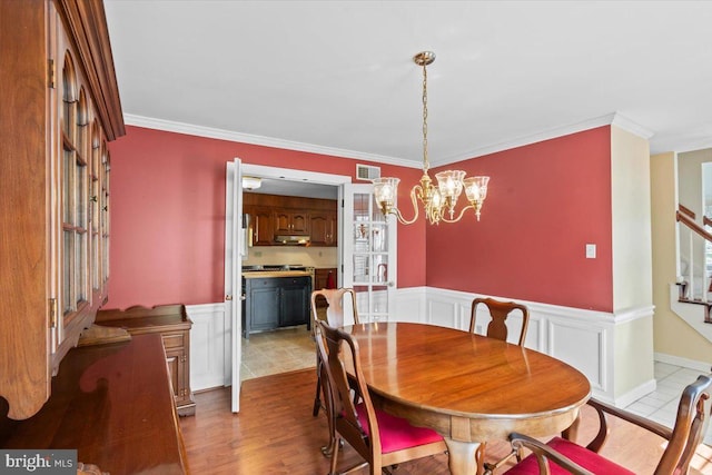 3161 Grande Oak Pl, Lancaster, PA 17601 - dining area with stairs, ornamental molding, visible vents, wainscoting, and a notable chandelier