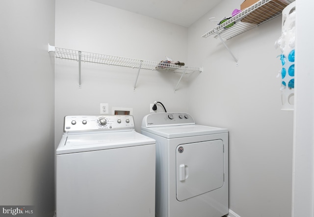 laundry room with separate washer and dryer and laundry area