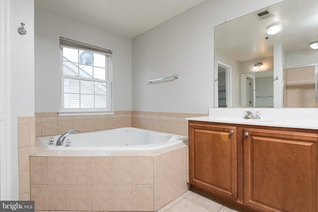 bathroom featuring tile patterned floors, vanity, a bath, and visible vents