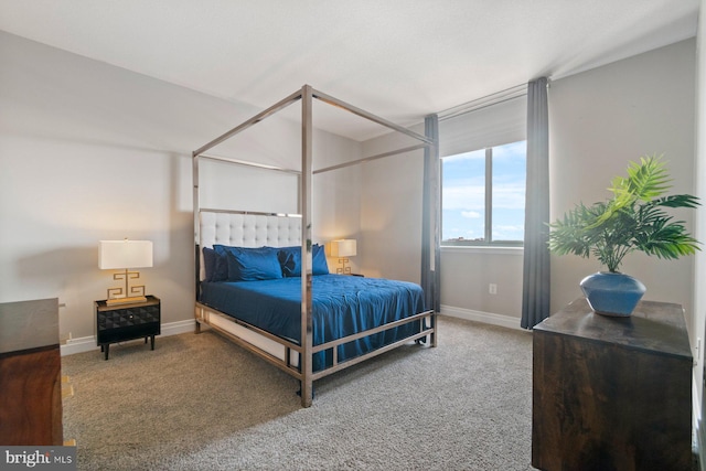 carpeted bedroom featuring baseboards