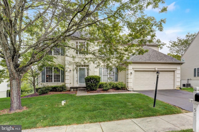 51 Knickerbocker Ln, Malvern, PA 19355 - view of front facade with asphalt driveway, an attached garage, a front yard, roof with shingles, and central AC unit