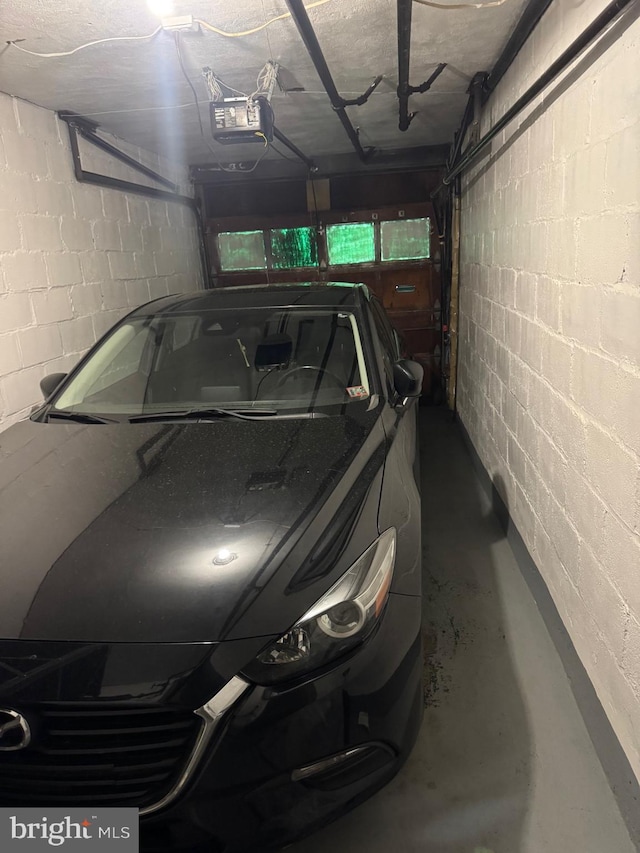 907 Birch St, Reading, PA 19604 - garage with a garage door opener and concrete block wall