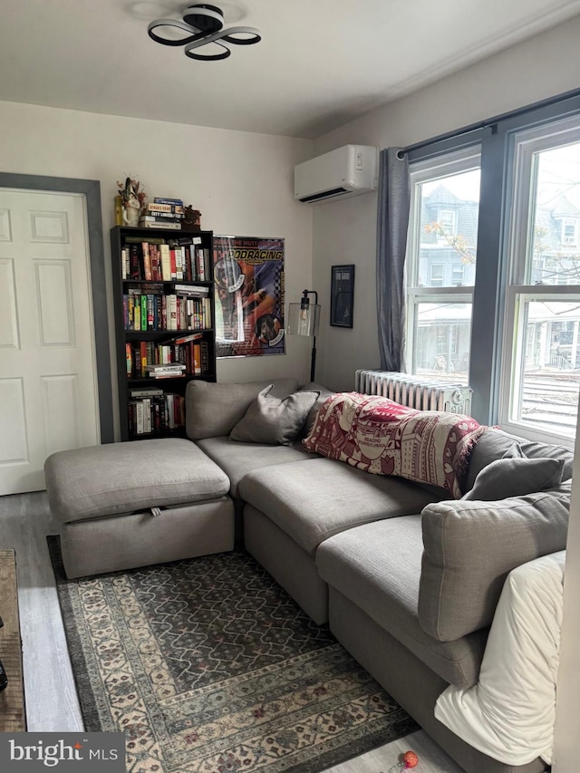 907 Birch St, Reading, PA 19604 - living area with radiator, an AC wall unit, and wood finished floors