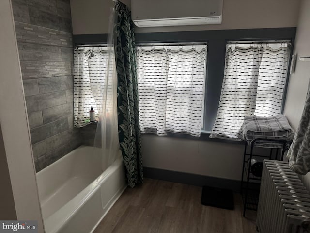 907 Birch St, Reading, PA 19604 - bathroom with an AC wall unit, radiator, wood finished floors, and shower / bathtub combination with curtain
