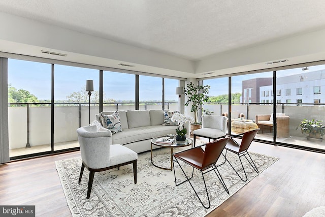 sunroom / solarium featuring a water view and visible vents
