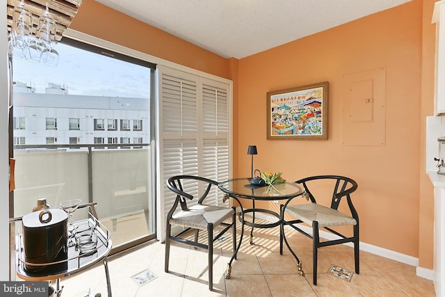 tiled dining area featuring baseboards