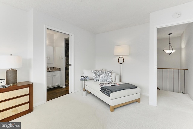 living area with carpet floors, baseboards, and an upstairs landing