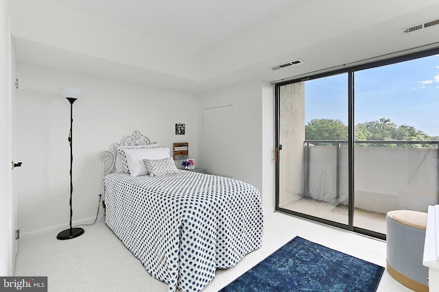 carpeted bedroom featuring baseboards, access to outside, and visible vents