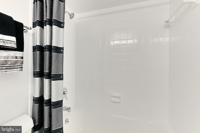 interior space with toilet and shower / bath combination with curtain