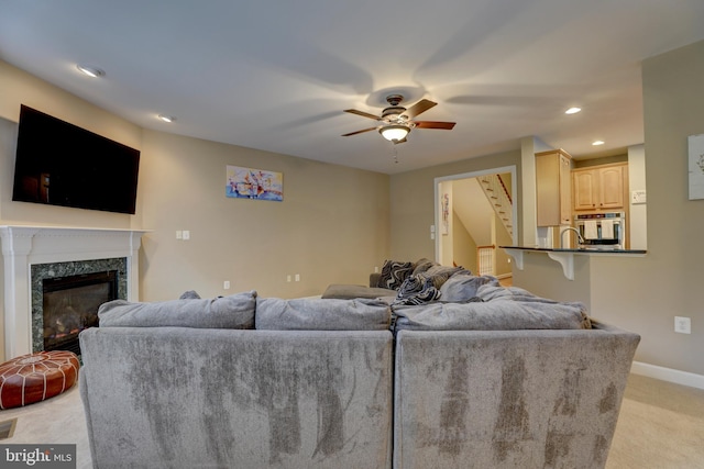 9124 Back Drop Dr, Perry Hall, MD 21128 - living room featuring light carpet, a ceiling fan, a high end fireplace, stairway, and recessed lighting