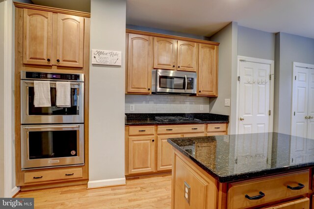9124 Back Drop Dr, Perry Hall, MD 21128 - kitchen featuring stainless steel appliances, light wood finished floors, dark stone counters, backsplash, and baseboards