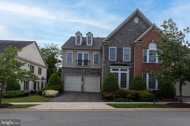 9124 Back Drop Dr, Perry Hall, MD 21128 - view of front of home featuring asphalt driveway, stone siding, an attached garage, and cooling unit