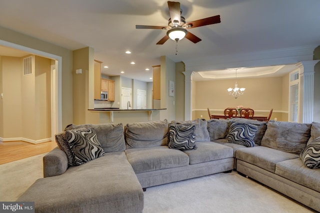 9124 Back Drop Dr, Perry Hall, MD 21128 - living area with ornate columns, a ceiling fan, a chandelier, recessed lighting, and light wood-type flooring