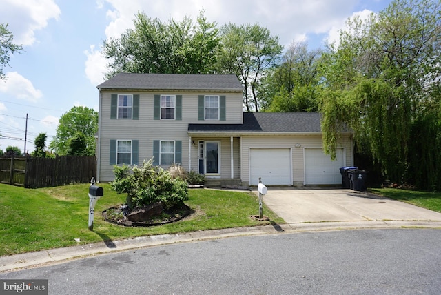 view of front facade with fence, an attached garage, driveway, and a front lawn