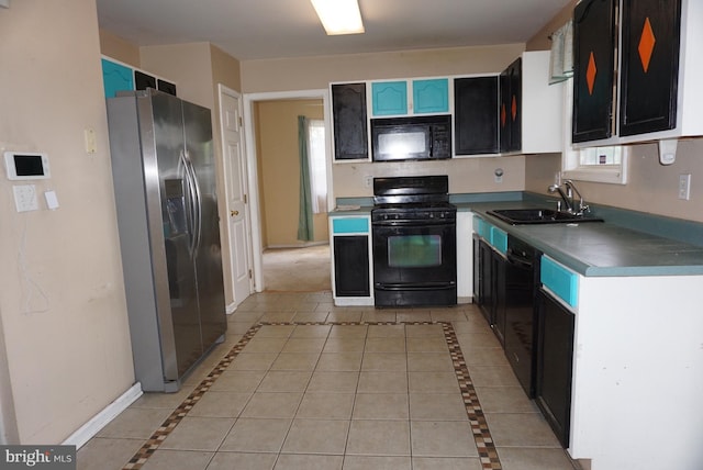kitchen featuring baseboards, a sink, and black appliances