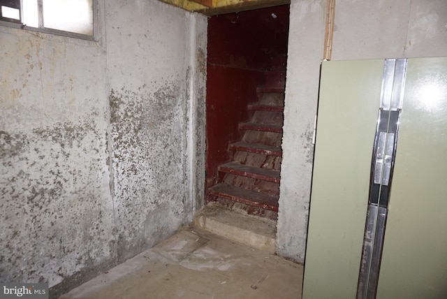 stairs featuring concrete floors