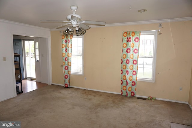 unfurnished room featuring carpet floors, ceiling fan, crown molding, and a healthy amount of sunlight