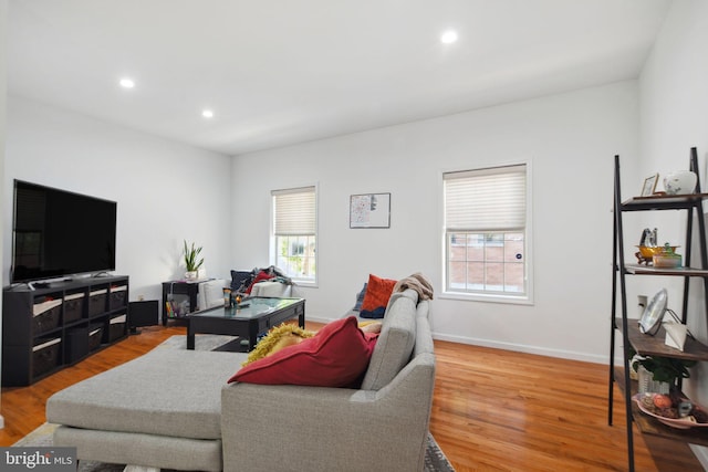living room with recessed lighting, baseboards, and wood finished floors