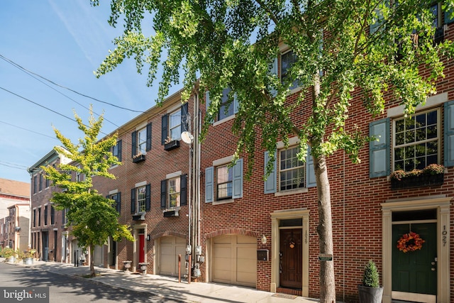 view of front of house featuring brick siding and an attached garage
