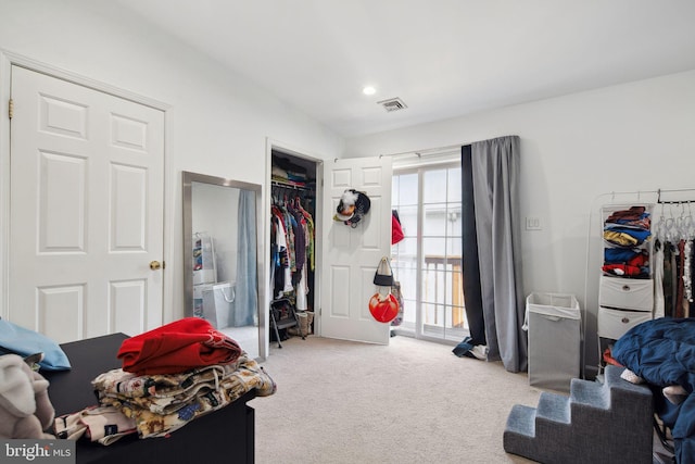 bedroom with visible vents, carpet, a closet, and access to exterior