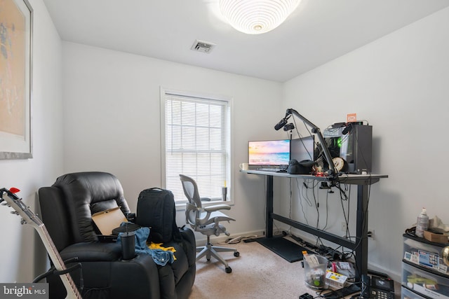 carpeted home office featuring visible vents and baseboards