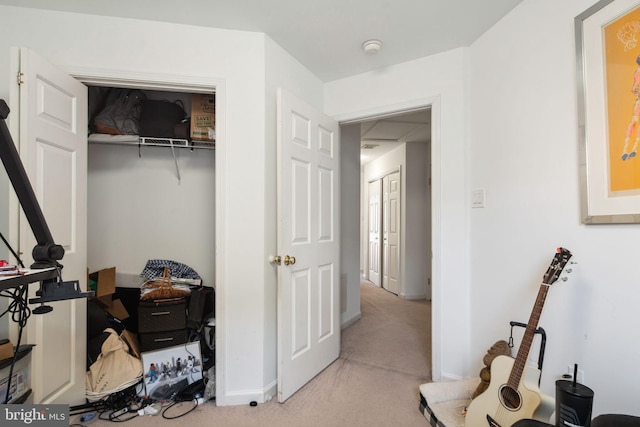 carpeted bedroom with baseboards and a closet